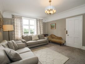 A living room with a sofa and lamp at The Old Vicarage in Kimbolton near Leominster