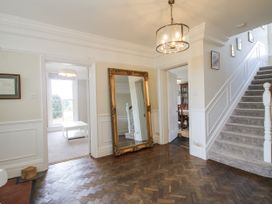 A hallway with a mirror and staircase at The Old Vicarage in Kimbolton near Leominster