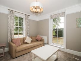 A living room with a sofa and coffee table at The Old Vicarage in Kimbolton near Leominster