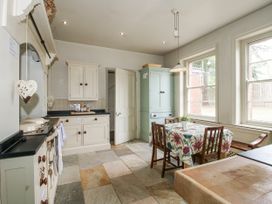A kitchen with a table and chairs at The Old Vicarage in Kimbolton near Leominster
