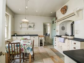 A kitchen with a table and chairs at The Old Vicarage Kimbolton near Leominster