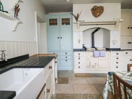 A kitchen with a sink and cupboard at The Old Vicarage in Kimbolton near Leominster