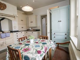 A kitchen with a dining table and chairs at The Old Vicarage Kimbolton near Leominster
