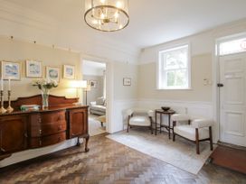 An entryway with a chest of drawers and armchairs at The Old Vicarage Kimbolton near Leominster