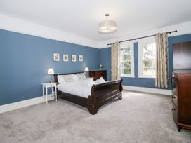 A bedroom with a bed and nightstand at The Old Vicarage in Kimbolton near Leominster