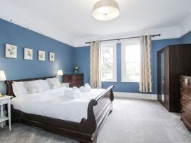 A bedroom with a bed and furniture at The Old Vicarage in Kimbolton near Leominster