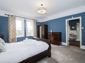 A bedroom with a bed and a dresser at The Old Vicarage Kimbolton near Leominster