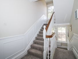 A staircase with a handrail and window at The Old Vicarage in Kimbolton near Leominster