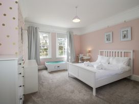 A bedroom with a bed and nightstand at The Old Vicarage in Kimbolton near Leominster