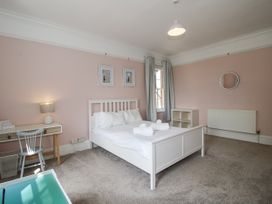 A bedroom with a bed and desk at The Old Vicarage in Kimbolton near Leominster