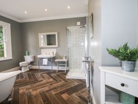 A bathroom with a bathtub and shower at The Old Vicarage in Kimbolton near Leominster