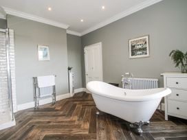 A bathroom with a bathtub and shower at The Old Vicarage in Kimbolton near Leominster