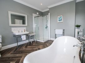 A bathroom with a bathtub and shower enclosure at The Old Vicarage in Kimbolton near Leominster