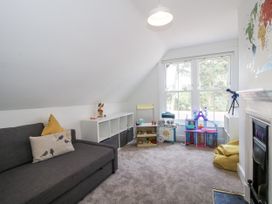 A playroom with a sofa and toy storage at The Old Vicarage in Kimbolton near Leominster