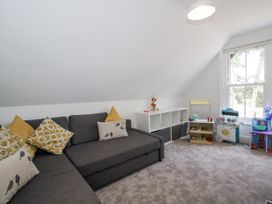 A playroom with a sofa and storage unit at The Old Vicarage in Kimbolton near Leominster