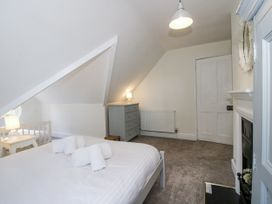 A bedroom with a bed and a grey drawer at The Old Vicarage in Kimbolton near Leominster