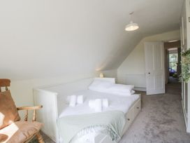 A bedroom with a bed and chair at The Old Vicarage Kimbolton near Leominster