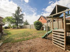A garden with a playset and trees at The Old Vicarage in Kimbolton near Leominster