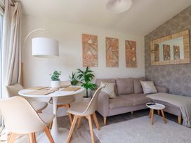 A living room with a table and chairs at Cozy Retreat in Tregolds