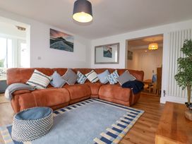 A living room with a sofa and coffee table at Ocean Edge in Sennen Cove