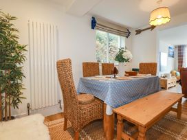 A dining room with a table and chairs at Ocean Edge in Sennen Cove