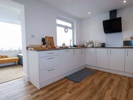 A kitchen with appliances and a window at Ocean Edge in Sennen Cove