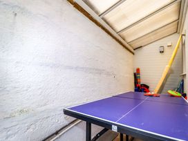 A ping pong table in a room with sports equipment at Ocean Edge in Sennen Cove