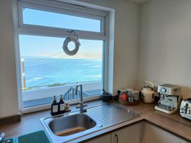A kitchen with a sink and coffee maker at Ocean Edge in Sennen Cove
