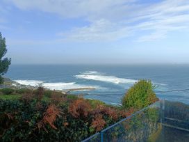 An ocean view with waves and vegetation at Ocean Edge Sennen Cove