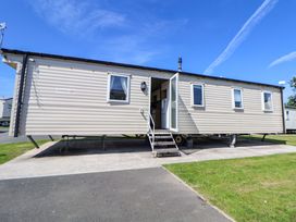 A caravan with a porch and stairs at Willerby Aurora B14 Towyn