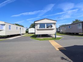 A row of static caravans with a pathway in Towyn