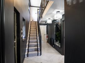 A hallway with stairs and light fixtures at Holly Farm near Brantham