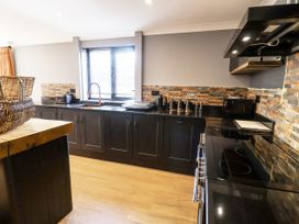 A kitchen featuring a stove, sink, and countertop at Holly Farm near Brantham