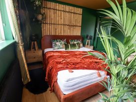 A bedroom with a bed and decorative pillows at Holly Farm near Brantham