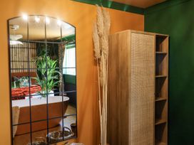 A bathroom with a bathtub and storage cabinet at Holly Farm near Brantham