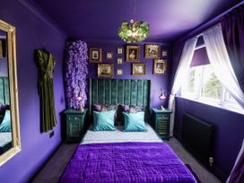 A bedroom with a bed and bedside table at Holly Farm near Brantham