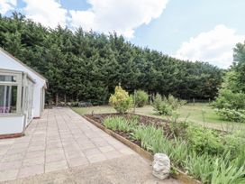 A garden with patio and trees at Holly Farm near Brantham