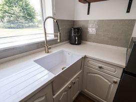 A kitchen with a sink and air fryer at Holly Farm near Brantham