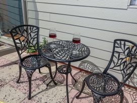 A table and two chairs with glasses on it at Holly Farm near Brantham