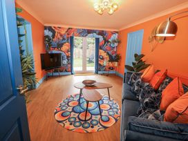 A living room with a sofa and television at Holly Farm near Brantham