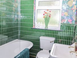 A bathroom with a bathtub and toilet at Holly Farm near Brantham