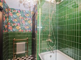A bathroom with a shower and bathtub at Holly Farm near Brantham