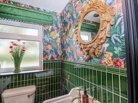 A bathroom with a toilet and sink at Holly Farm near Brantham