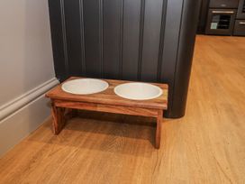 A pet feeding stand with ceramic bowls at Holly Farm near Brantham