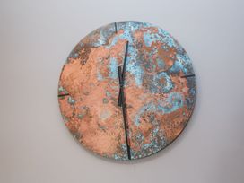 A wall clock with a copper and blue design at Holly Farm near Brantham