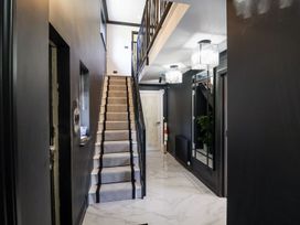 A hallway with stairs and mirrors at Holly Farm near Brantham
