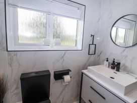 A bathroom with a toilet and sink at Holly Farm near Brantham