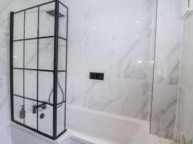A bathroom with a shower and bathtub at Holly Farm near Brantham
