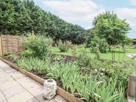 A garden with flowers and a decorative sculpture at Holly Farm near Brantham