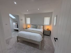 A bedroom with a bed and bedside table at Bader House in Ipswich